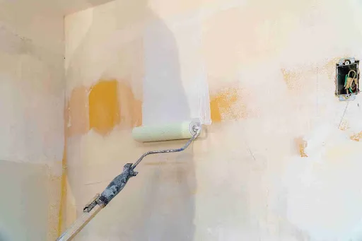 How to Paint a Bathroom: Step-by-Step Pro Guide A paint roller applying primer to bathroom walls during surface preparation in a bathroom painting guide