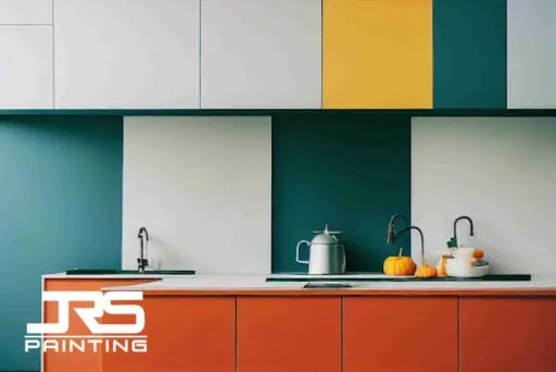 Modern kitchen cabinets with smooth painted surfaces, illustrating spray vs brush finish differences in cabinet painting results.