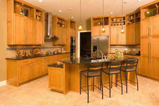 Traditional honey-tone 1990s Oak Cabinets in Chandler kitchen with raised panels and bar seating.