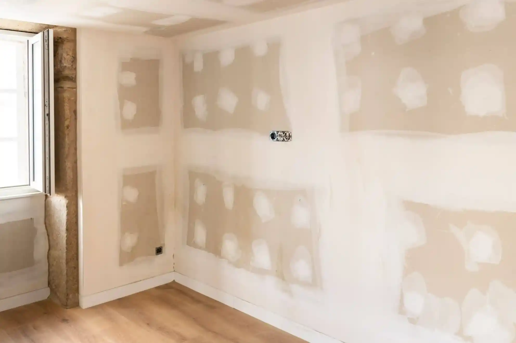 drywall-or-stucco-interior-drywall-wall-prep Drywall or stucco interior project with patched drywall seams and screw holes before painting