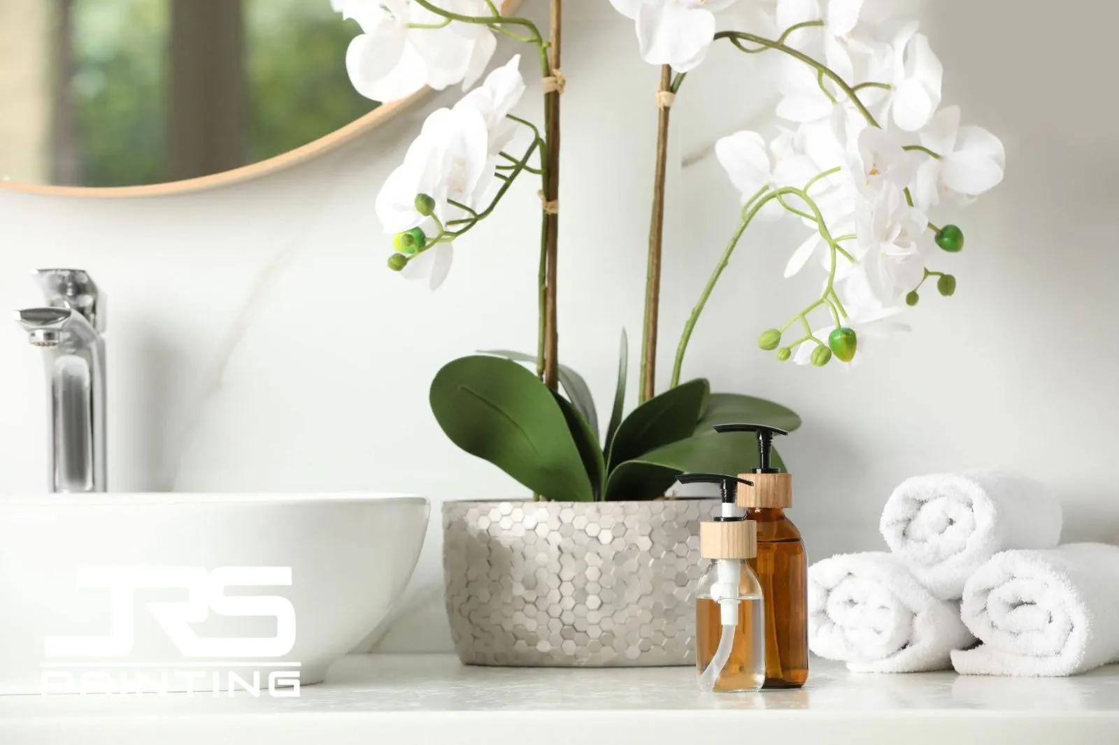 gray-bathroom-paint-colors-orchid-towels Bright gray bathroom vanity with white orchid, rolled towels, sink, and soap dispensers