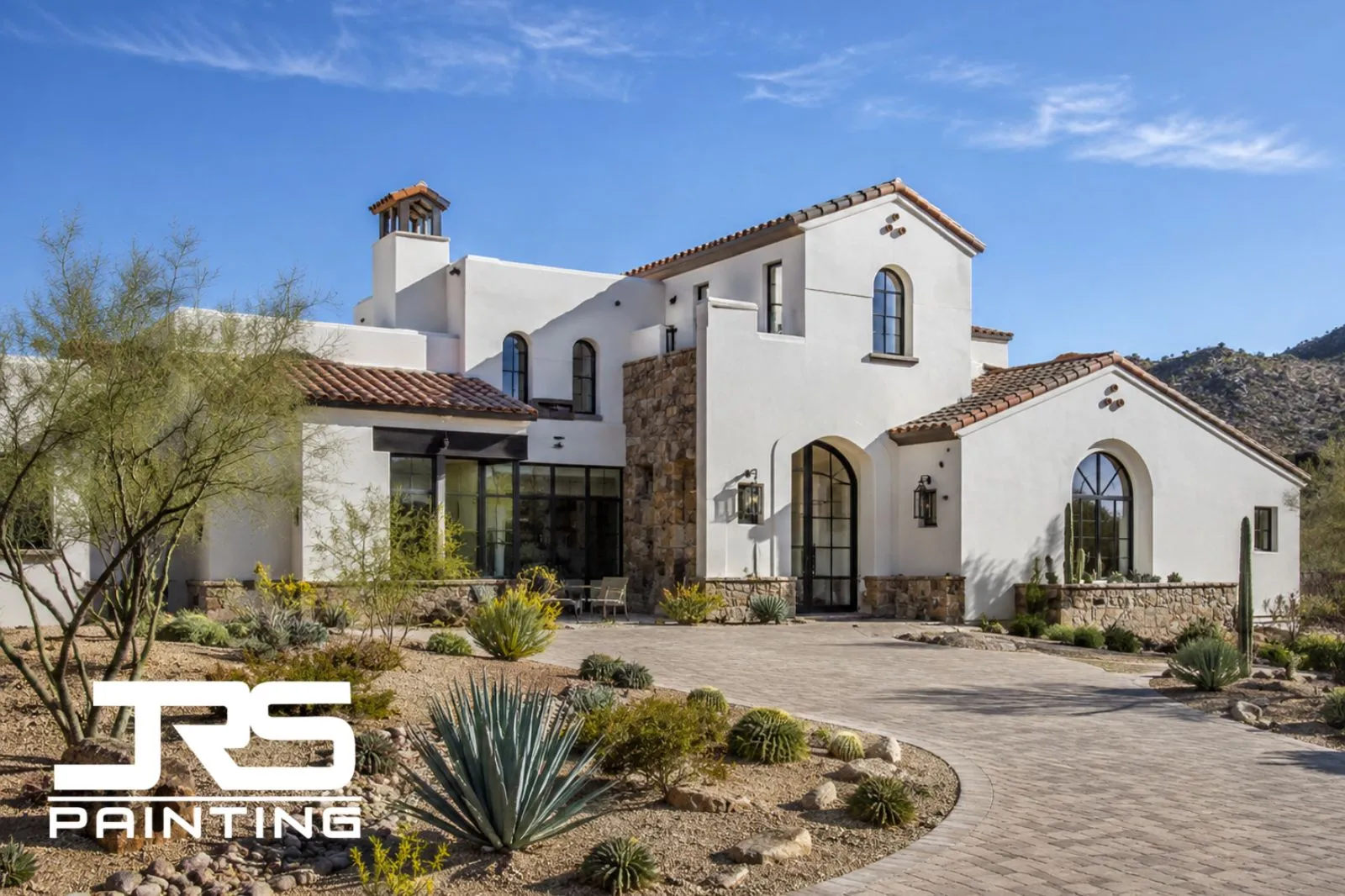 heat-reflective-exterior-paint-colors-warm-white-arizona-home Warm white Arizona stucco home showing heat reflective exterior paint colors with tile roof and desert landscaping